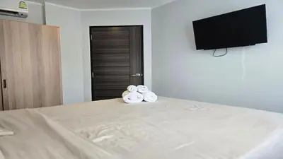 two rolls of towels sitting on top of a bed at Island Escape 1BR T1-206 in Chalong
