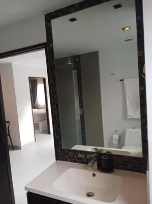 a bathroom with a sink and a large mirror at Large Corner Apartment 1BR - NV-207 in Chalong