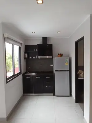 a kitchen with a refrigerator and a sink at Large Corner Apartment 1BR - NV-207 in Chalong