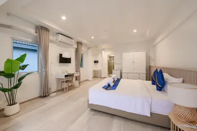a bedroom with a large bed and a desk at Little Home Ao Nang in Ao Nang Beach