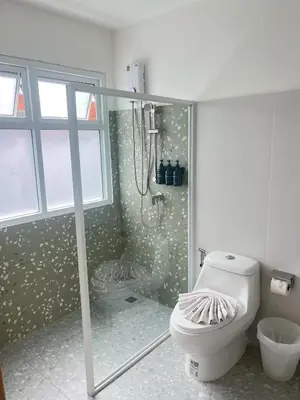a bathroom with a shower and a toilet in it at Little Home Ao Nang in Ao Nang Beach