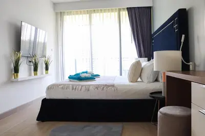 a bedroom with a bed with a large window at Cassia 3BR Sea View apt by NLA in Bang Tao Beach