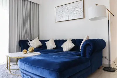 a blue couch in a living room with a table at Cassia 3BR Sea View apt by NLA in Bang Tao Beach