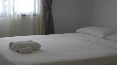 a white bed with a stuffed animal on it at Boutique Comfort 1BR T2-410 in Chalong