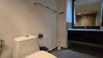 a bathroom with a toilet and a sink and a mirror at Boutique Comfort 1BR T2-410 in Chalong