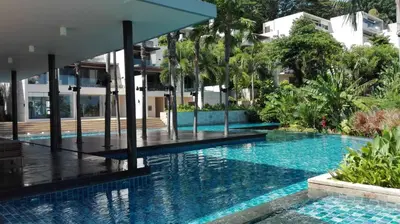 a swimming pool in the middle of a building at Panoramic Sea View Luxury Apartment - Leelawadee21 in Kata Beach