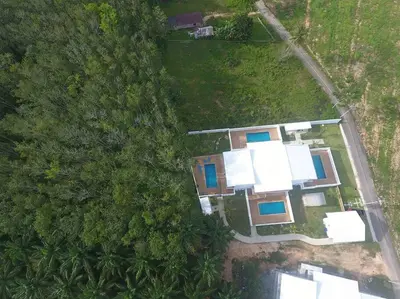 an overhead view of a house in the forest at Amidst tropical plantations and striking mountain views in Ban Khlong Haeng
