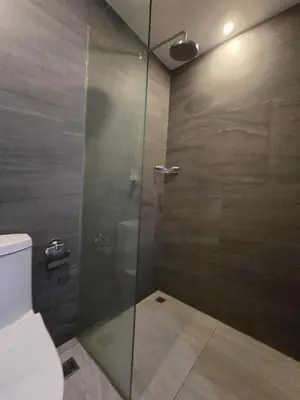 a bathroom with a glass shower with a toilet at Cozy & Modern -1BR - T2 416 in Phuket Town
