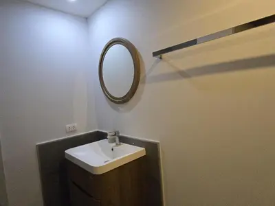 a bathroom with a sink and a mirror on the wall at Cozy & Modern -1BR - T2 416 in Phuket Town