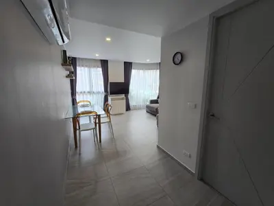 a hallway with a table and chairs in a room at Cozy & Modern -1BR - T2 416 in Phuket Town