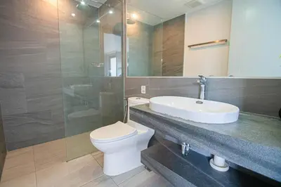 a bathroom with a toilet and a sink and a shower at Modern & Stylish Apartment-2BR - NV-518 in Phuket Town