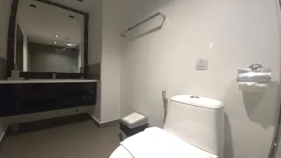 a bathroom with a white toilet and a sink at Tranquil Tide 1 BR T1-605 in Chalong