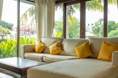 a living room with a couch with yellow pillows at Surin 4-Bed Luxury Retreat with Private Pool V131 in Thalang