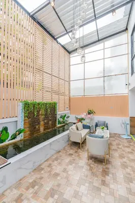 a lobby with a large window and a large aquarium at De Blue Sea Rawai Hotel in Ban Saiyuan (1)