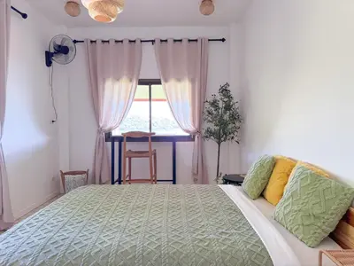 a bedroom with a large bed and a window at Sea Dreamer Ao Yon Beach House in Ban Ao Makham