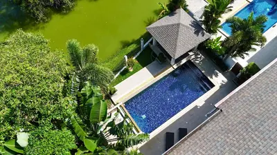 an overhead view of a swimming pool next to a house at Lake view 3 bedrooms Pool Villa in Rawai Beach