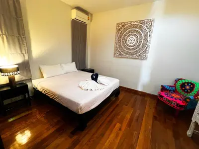 a bedroom with a bed with a cat sitting on it at Lake view 3 bedrooms Pool Villa in Rawai Beach