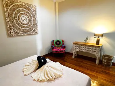 a room with a bed and a table with a lamp at Lake view 3 bedrooms Pool Villa in Rawai Beach