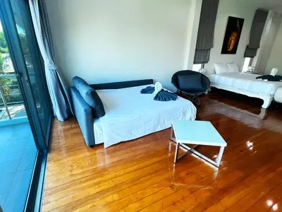 a bedroom with a bed and a desk and a table at Lake view 3 bedrooms Pool Villa in Rawai Beach