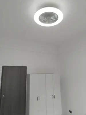 a ceiling light in a bathroom with white cabinets at Suthida Resort in Rawai Beach