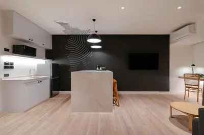 a kitchen and living room with a counter and a table at Blu Monkey Hub and Hotel Laguna, Bangtao Phuket in Bang Tao Beach