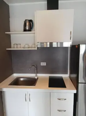 a small kitchen with a sink and a refrigerator at Fully Furnished Apartment - NV-622 in Chalong