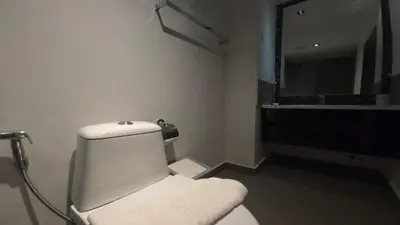 a bathroom with a white toilet and a mirror at Urban loft 1BR T1-706 in Chalong