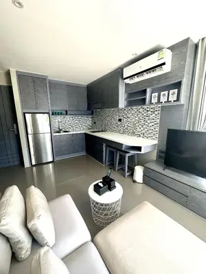 a living room with a couch and a kitchen at 1BDR King size bed 3 Restaurants 500m to beach in Kamala Beach