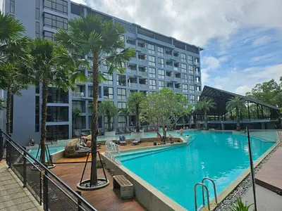 a large swimming pool in front of a building at 1BDR Rooftop bar The biggest gym Spa centre in Kamala Beach
