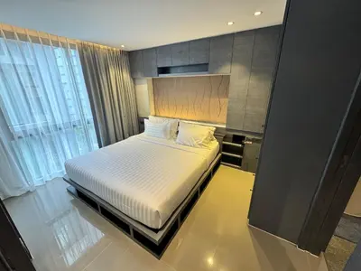 a bedroom with a bed and a large window at 1BDR Rooftop bar The biggest gym Spa centre in Kamala Beach