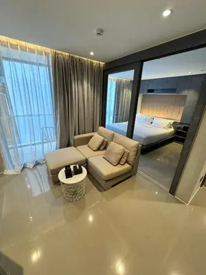 a living room with a couch and a bed at 1BDR Rooftop bar The biggest gym Spa centre in Kamala Beach