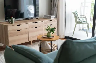 a living room with a tv and a table at Title Halo Nature Touch 40m2 King Bed Naiyang in Nai Yang Beach