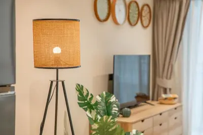 a lamp in a living room with a television at Title Halo Nature Touch 40m2 King Bed Naiyang in Nai Yang Beach