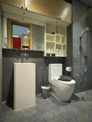 a bathroom with a toilet and a glass shower at ReLife NaiHarn Beach by Mill in Rawai Beach