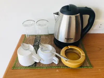 a tray with a coffee pot and two glasses of milk at Global Hotel Beach View in Patong Beach