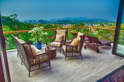a balcony with chairs and a table with a view at Fully Serviced Grand Villa Luxury Time Phuket in Bang Tao Beach