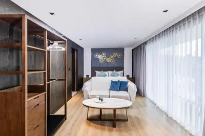 a living room with a bed and a table at Studio Aurel 1BRTropical ViewsShuttle to NaiHarn in Rawai Beach