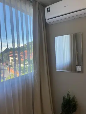 a window with a curtain in a room at Cozy corner in Ao Nang Beach