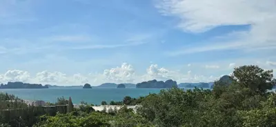 a view of a body of water with mountains in the background at Krabi Glass House Sea View Villa in Tab Kaek Beach