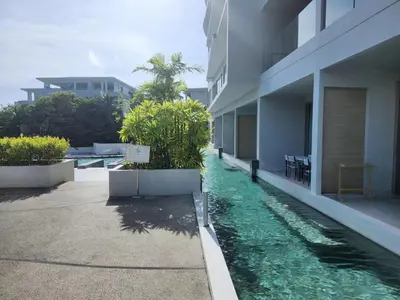 a swimming pool in front of a building at Veloche Karon 12 in Karon Beach