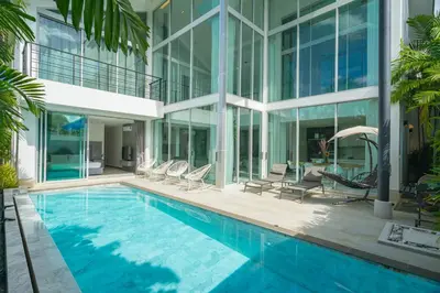 a swimming pool in front of a building at Spacious 4BR Pool Villa at Grand View in Bangtao in Bang Tao Beach