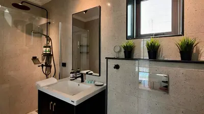 a bathroom with a sink and a mirror at Phuket Villa Sofia in Ban Phak Chit
