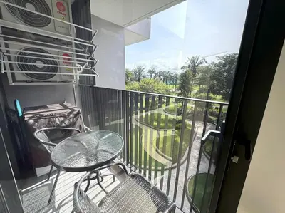 a balcony with a table and chairs on a balcony at Modern Laguna Skypark apartments by Lofty in Bang Tao Beach