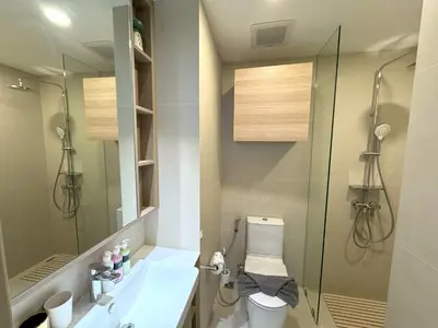 a bathroom with a shower and a toilet and a sink at Modern Laguna Skypark apartments by Lofty in Bang Tao Beach