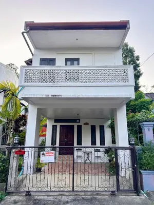 a white house with a gate in front of it at 103-25 Kathu Waterfall in Phuket Town