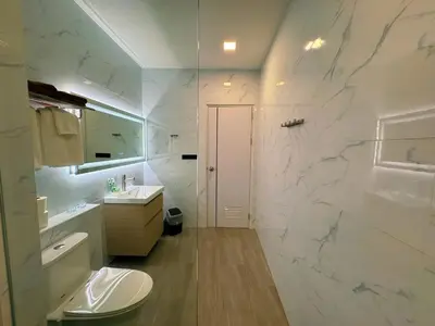 a white bathroom with a sink and a toilet at Ground Floor Zen Space Kamala in Kamala Beach