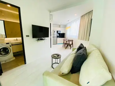 a living room with a couch and a table at Oceana Kamala in Kamala Beach