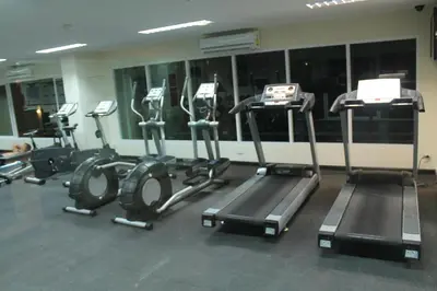 a gym with several tread machines in a room at Nice Apartment large pool in nice residence central Patong beach in Patong Beach