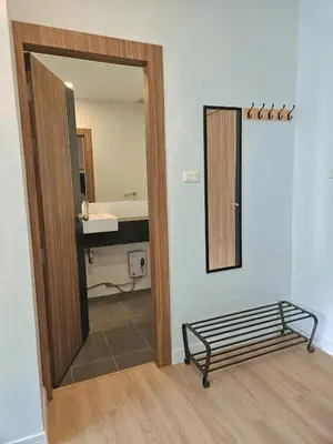 a bathroom with a mirror and a bed in a room at The Olive Studio Room at Chic Condominium in Karon Beach