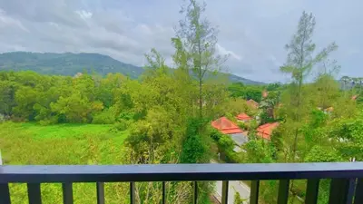 a view from the balcony of a house at Zcape 2 Boat Avenue, Laguna Brand New Renovated One bedroom Apartment with the Mountain View in Bang Tao Beach
